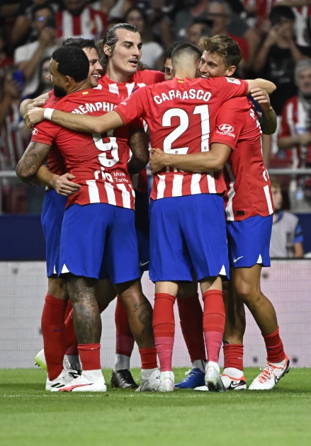 Atletico hit three to take early Liga lead