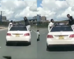 Two charged with riding in a dangerous position after being captured hanging on moving car