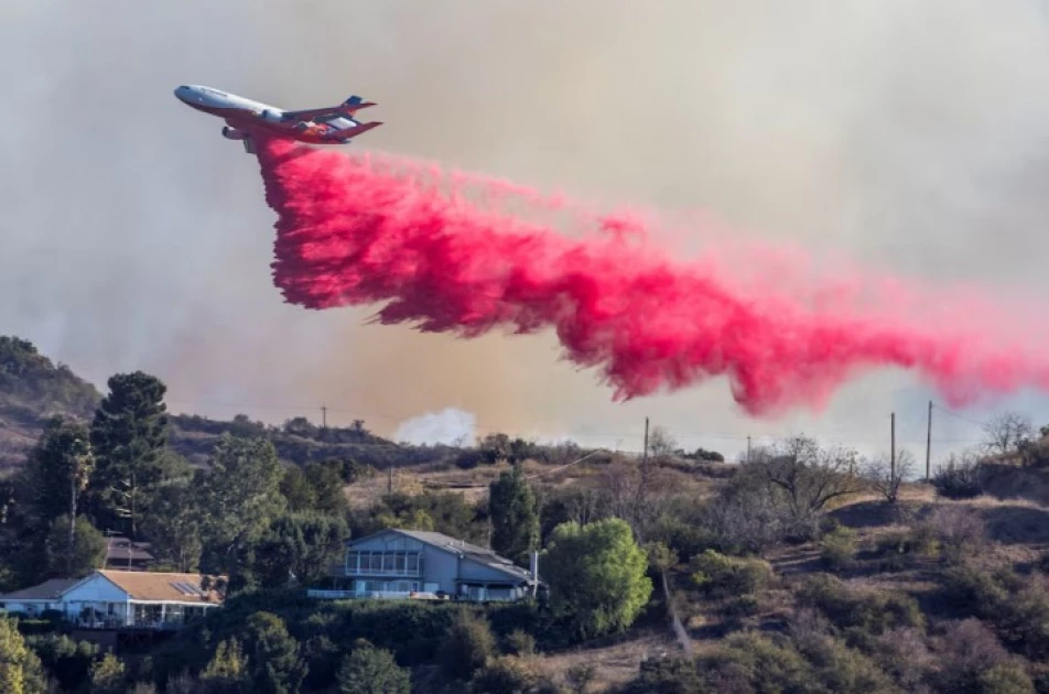 Aerial assault aims to stem LA Palisades fire eastward spread