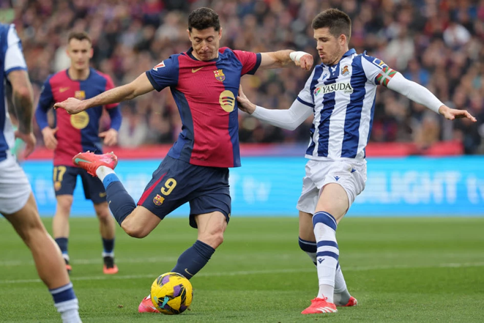 Barca thrash 10-man Real Sociedad to reclaim top spot