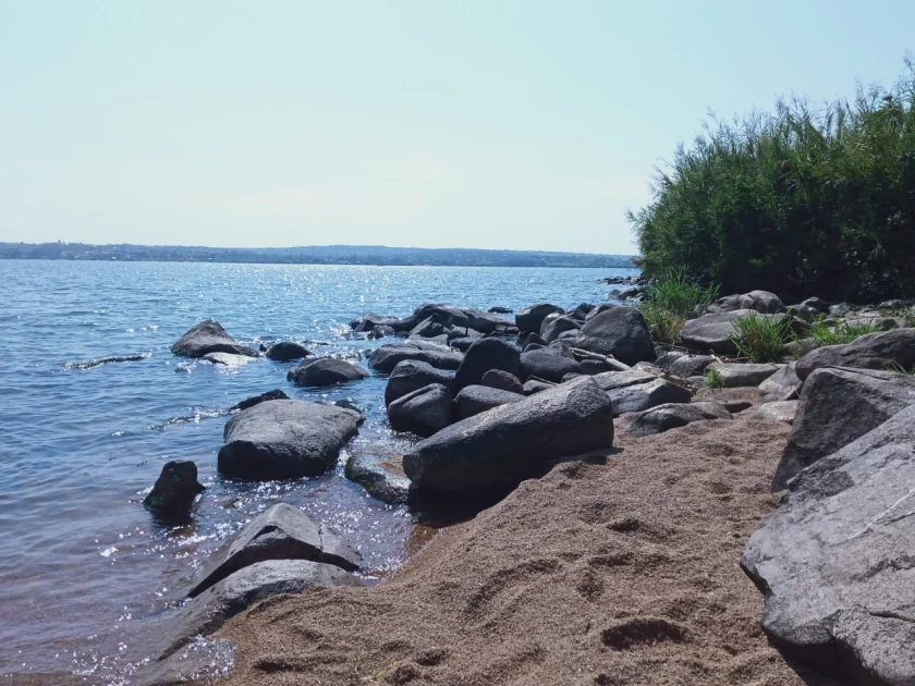 Residents worried even as swollen Lake Victoria retreats, exposing large rocks